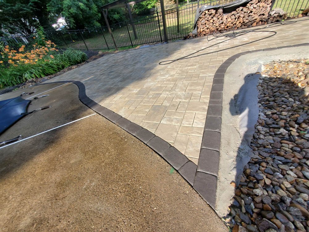 Elegant masonry paver patio with custom layout and natural stone finishes in New Hampshire