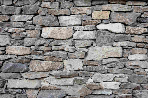 Decorative stone wall built with natural masonry for outdoor landscaping